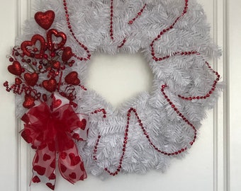 Valentines wreath adorned with hearts and a pretty heart bow