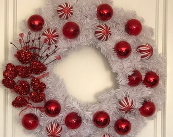 Valentine’s Day sparkly red hearts and red ornaments. Lighted around a white 24 inch wreath.