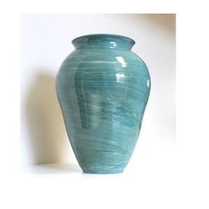 May include: A large, teal-colored ceramic vase with a smooth, glossy finish. The vase has a rounded, bulbous shape and a slightly flared opening.