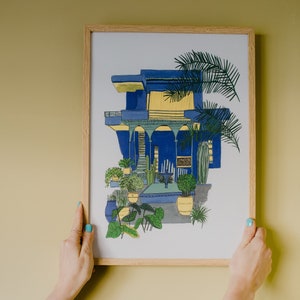 Jardin Majorelle botanical garden print in blue and yellow with tropical plants. Moroccan travel inspired wall art.