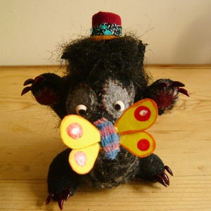Werewolf with magnetic, attacheable butterfly on its nose!