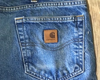 Artist/carpenter worn carhartt jeans raw hem