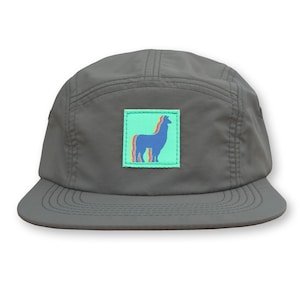 May include: A gray 5-panel cap with a green square patch featuring a blue llama silhouette with rainbow stripes.
