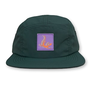 May include: A dark green, five-panel cap with a flat brim. A square patch on the front features an orange lizard design on a purple background. The cap is made of a smooth, durable fabric and has a structured fit.