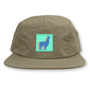May include: A khaki green 5-panel cap with a patch featuring a blue llama silhouette with rainbow stripes on a light green background.