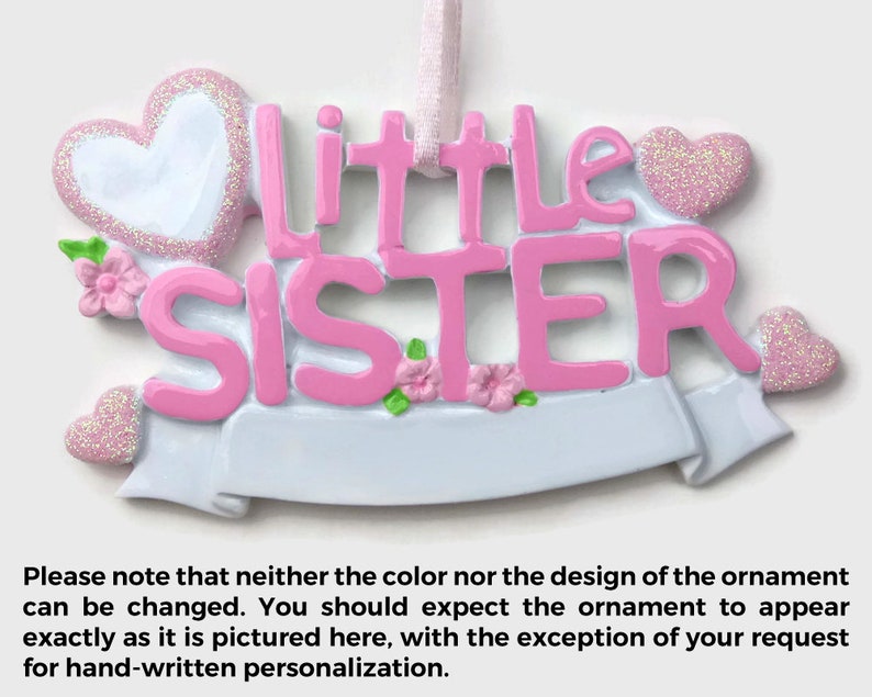 May include: Pink and white Christmas ornament with the words "little sister" and two hearts.