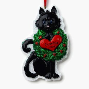 May include: Black cat Christmas ornament with a green wreath and a red heart that says "Frankie - 2019".