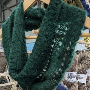 100% qiviut hand knit mobius each one is unique in that the pattern is free form meaning no two are alike Hand Knitted Mobius Hand Dyed Shown in Aurora Green and Bluest Blueberry Made in Alaska A circular Scarf worn around the neck