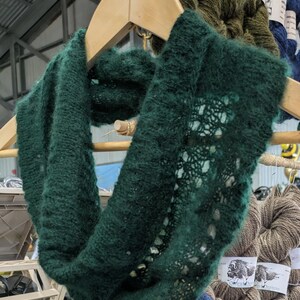 100% qiviut hand knit mobius each one is unique in that the pattern is free form meaning no two are alike Hand Knitted Mobius Hand Dyed Aurora Green Made in Alaska A circular Scarf worn around the neck