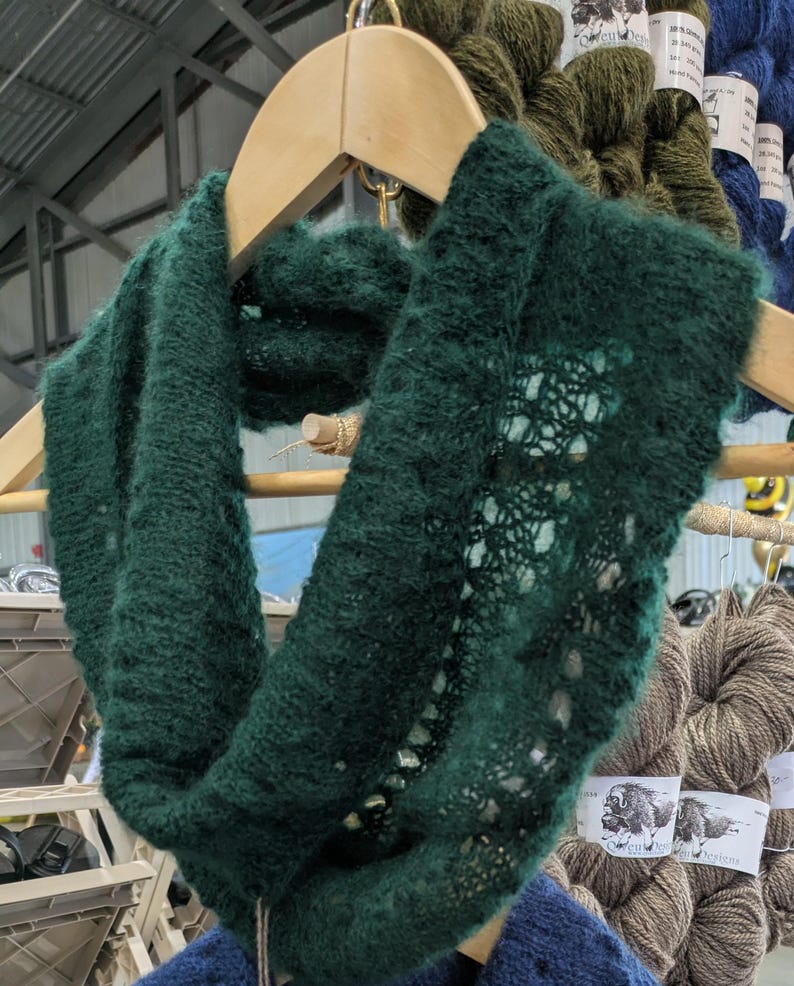 100% qiviut hand knit mobius each one is unique in that the pattern is free form meaning no two are alike Hand Knitted Mobius Hand Dyed Aurora Green Made in Alaska A circular Scarf worn around the neck