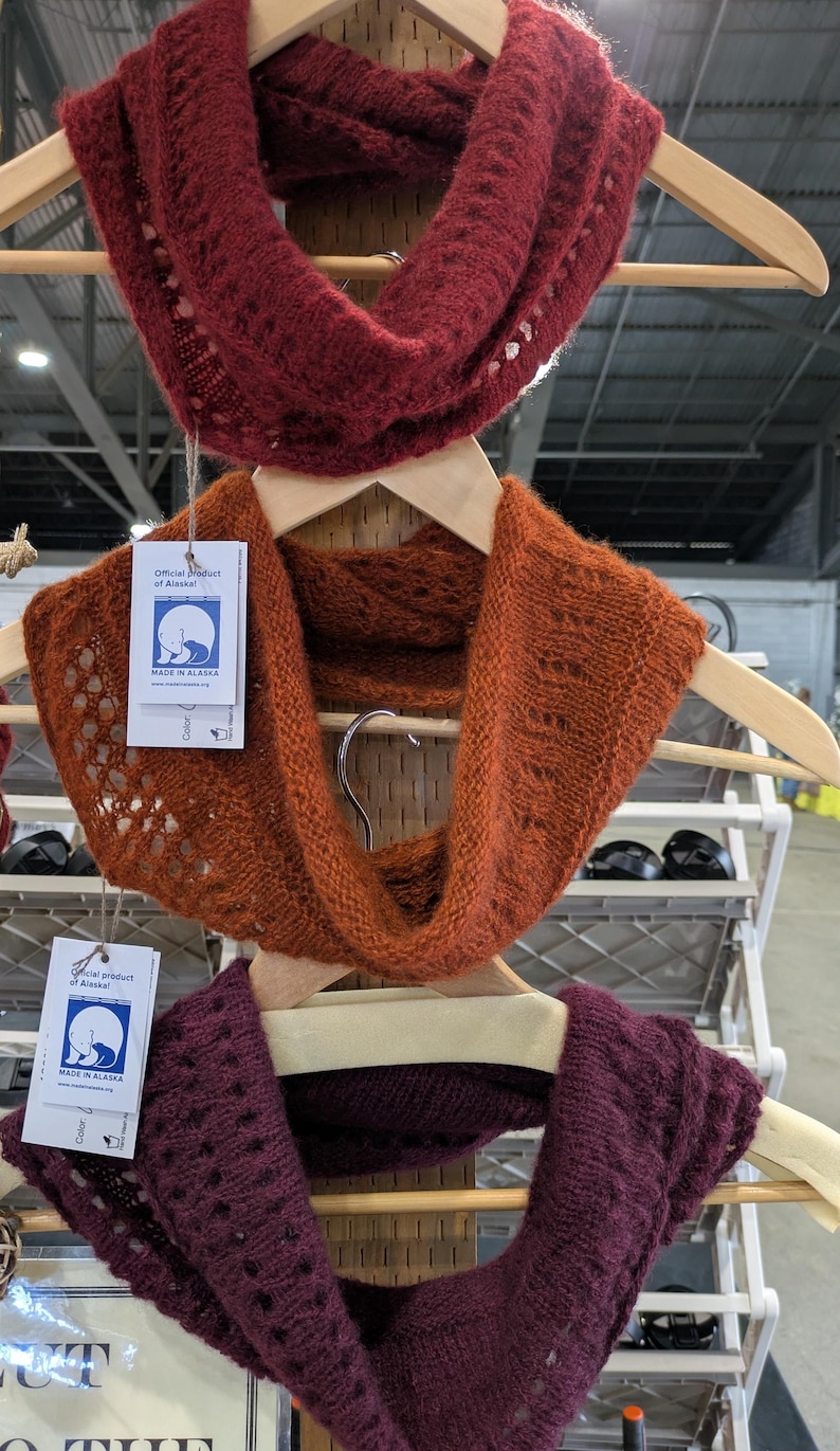 100% qiviut hand knit mobius each one is unique in that the pattern is free form meaning no two are alike Hand Knitted Mobius Hand Dyed Shown in Cranberry Willow and Raspberry Made in Alaska A circular Scarf worn around the neck