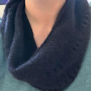 100% qiviut hand knit mobius each one is unique in that the pattern is free form meaning no two are alike Hand Knitted Mobius Hand Dyed Black Made in Alaska A circular Scarf worn around the neck