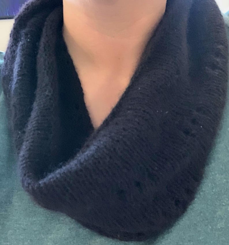 100% qiviut hand knit mobius each one is unique in that the pattern is free form meaning no two are alike Hand Knitted Mobius Hand Dyed Black Made in Alaska A circular Scarf worn around the neck
