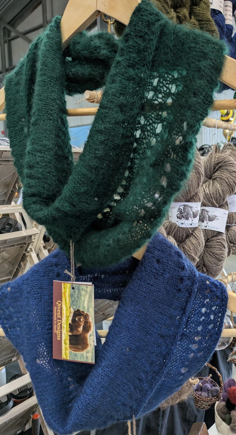 100% qiviut hand knit mobius each one is unique in that the pattern is free form meaning no two are alike Hand Knitted Mobius Hand Dyed Shown in Aurora Green and Bluest Blueberry Made in Alaska A circular Scarf worn around the neck