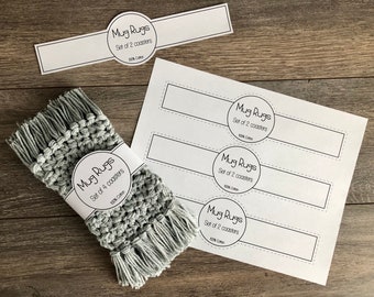 May include: A set of four grey crocheted mug rugs with fringe. The mug rugs are packaged with a label that reads "Mug Rugs Set of 4 coasters 100% Cotton".
