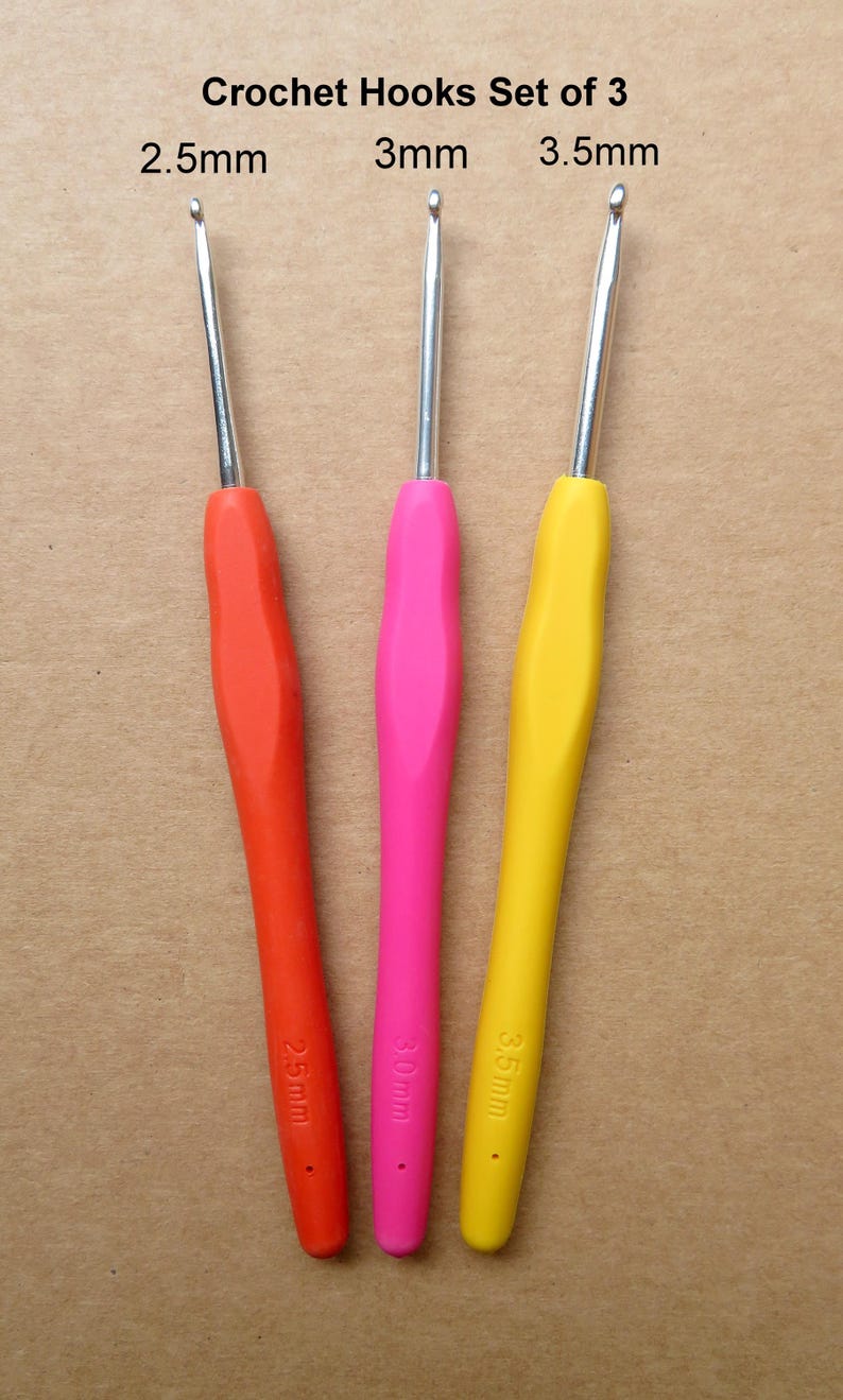 May include: Set of three crochet hooks with colorful handles. The handles are red, pink, and yellow. The text "Crochet Hooks Set of 3" is at the top. The hook sizes are 2.5mm, 3mm, and 3.5mm.