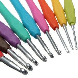 May include: A collection of crochet hooks with colorful, ergonomic handles in shades of purple, teal, blue, pink, orange, yellow, and green. The metal hooks are silver and vary in size. These tools are designed for yarn crafts and fiber art projects.