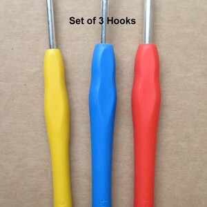 May include: Set of 3 crochet hooks with colorful handles. The hooks are 3.5mm, 4mm, and 4.5mm. The handles are yellow, blue, and red. The text "Set of 3 Hooks" is visible.