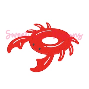 May include: A red crab design with white accents and small black eyes. The crab has large claws and multiple legs. The text "Sweet Designs" is in pink script above the crab. This design is suitable for embroidery or applique projects.