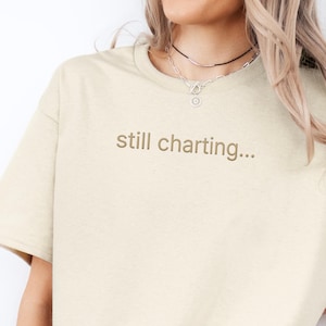 Embroidered Still Charting Nurse Gift , Minimal RN Humor Tee for Healthcare worker coworker Present