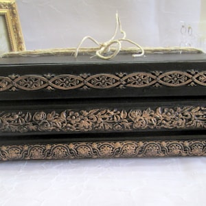 Decorative Black book stack with hand cast clay motifs ,  beautiful on coffee table or unusual decor  in bedroom, living room or library