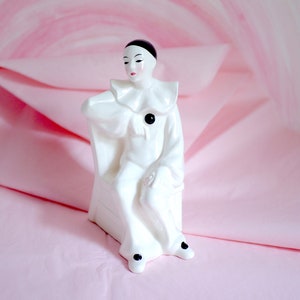 Ceramic Harlequin clown figurine sitting