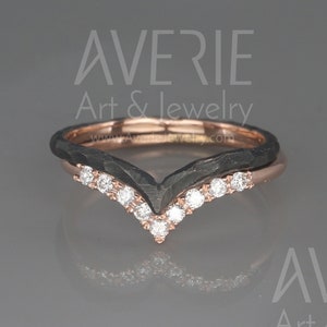 May include: A black and rose gold ring with a V-shaped band and a row of small diamonds. The ring is set on a gray background. AVERIE Art & Jewelry www.AverieJewelry.com