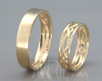 May include: Two gold wedding bands. One band is a simple, flat design. The other band has a delicate, intricate design.