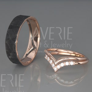 May include: A pair of wedding bands. The band on the left is black and has a hammered finish. The band on the right is rose gold and has a V-shaped design with small diamonds.
