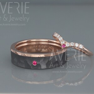 May include: A pair of wedding bands, one with a black carbon fiber finish and a rose gold band, and the other a rose gold band with a V-shaped row of diamonds and a ruby.