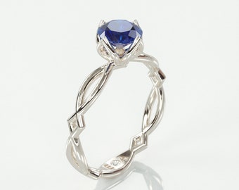 Keltische verlovingsring met blauwe saffier | Ring van 14k witgoud bezet met een natuurlijke blauwe saffier en een bijpassende, verborgen diamant.