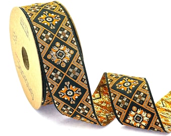 May include: A spool of black and gold ribbon with a repeating pattern of orange and gold floral designs. The ribbon is on a brown spool with the word "Fantastic" printed on it.
