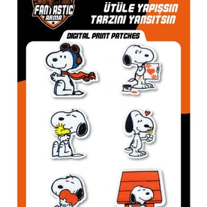 May include: A set of six iron-on digital print patches featuring Snoopy in various poses, including wearing aviator gear, painting, hugging Woodstock, holding a flower, holding a heart, and standing by a doghouse, on a branded card.