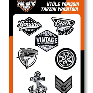 May include: A collection of six black and white iron-on patches on a white backing card. Designs include a Genuine Product badge, a Los Angeles Beach California emblem, a Vintage Salt Lake City Utah mountain logo, a shark, a compass, an anchor, and a chevron.