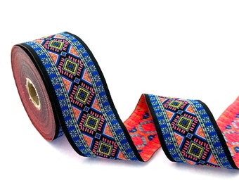 May include: A roll of colorful patterned trim with a black background and geometric designs in shades of pink, blue, yellow, and white.
