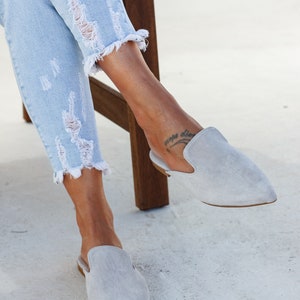 Woman wearing Loraine grey suede mules