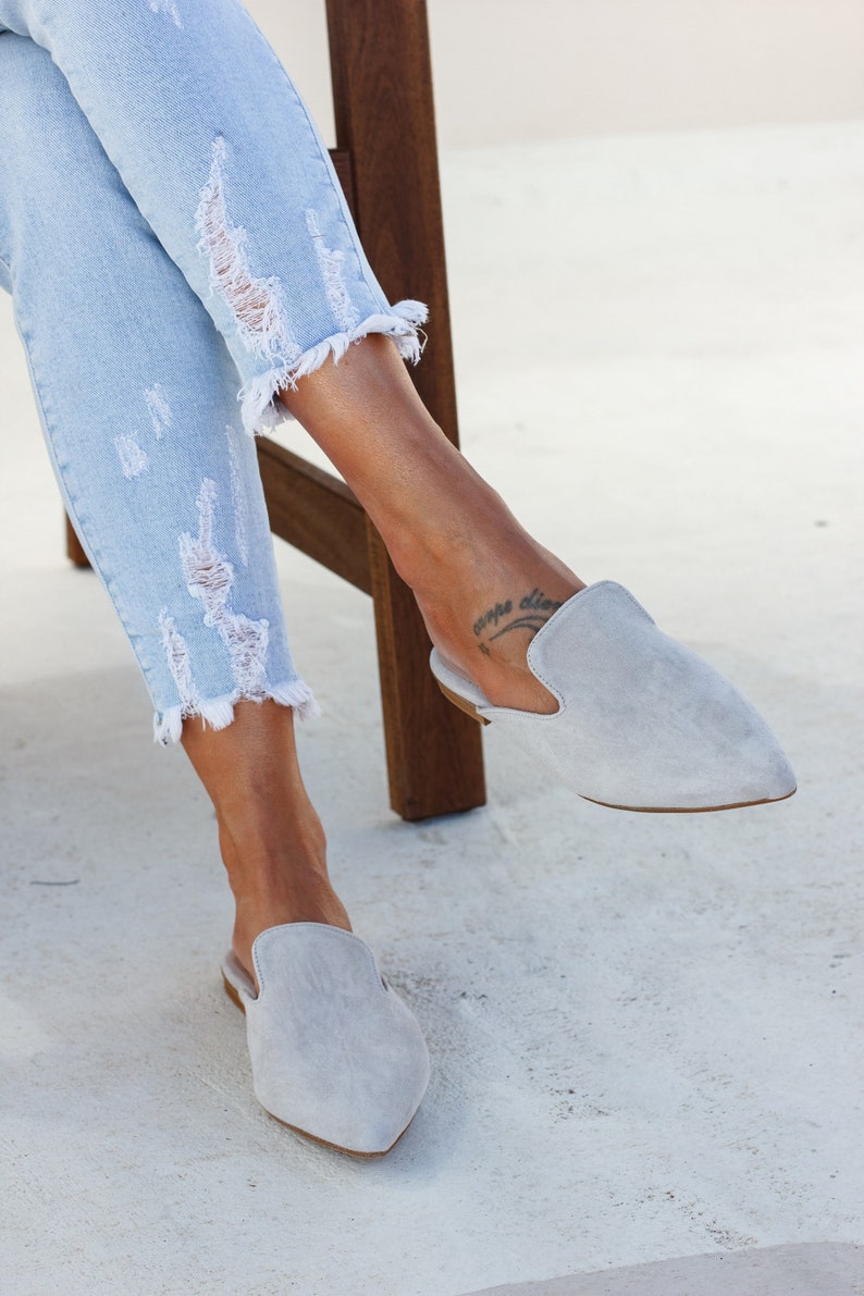 Woman wearing Loraine grey suede mules