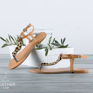 Close-up leopard T-Strap and buckle closure — HYDRA