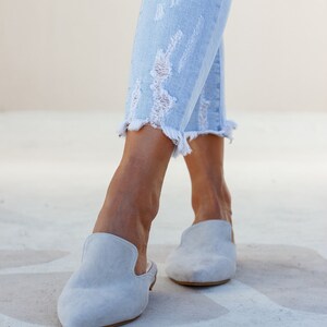 Woman wearing Loraine grey suede mules — neutral outfit look