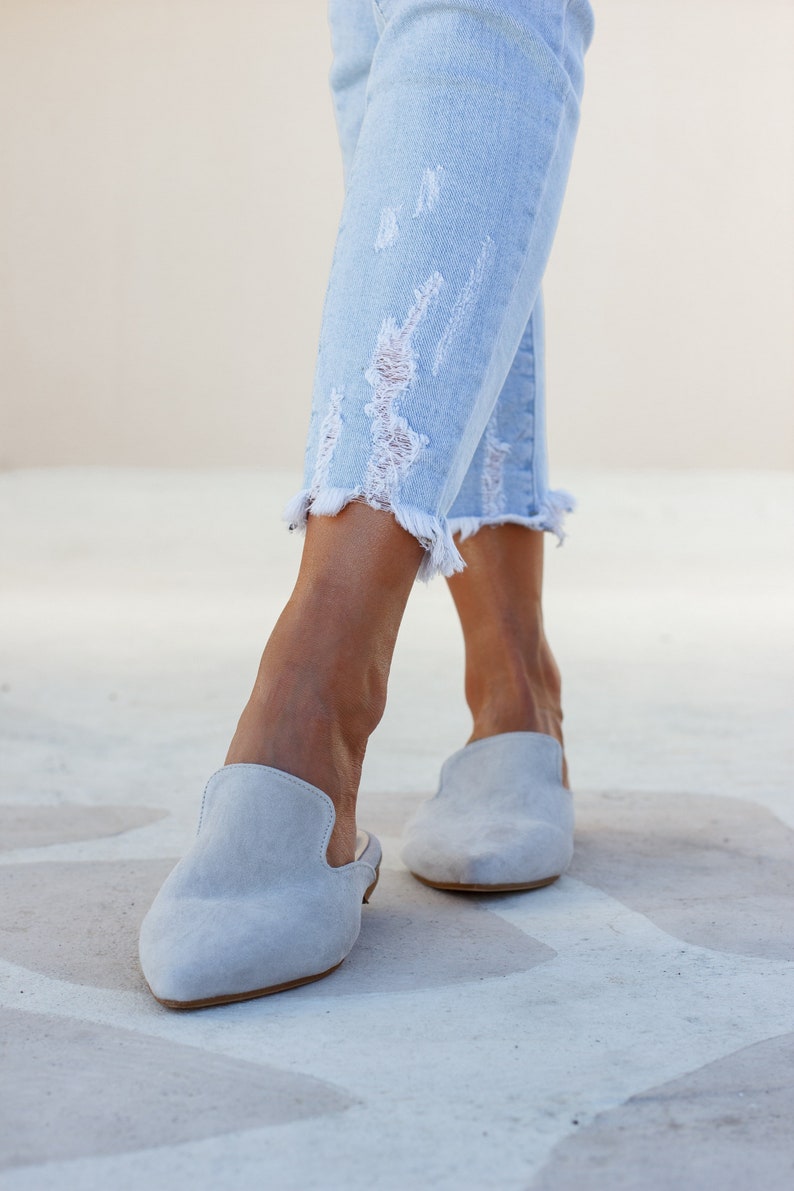 Woman wearing Loraine grey suede mules — neutral outfit look