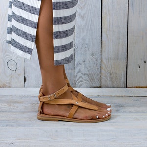 Close-up natural veg-tan straps and grain — ankle strap detail
