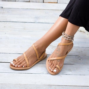 Close-up of the natural leather straps. Highlights the smooth texture of the vegetable-tanned leather.