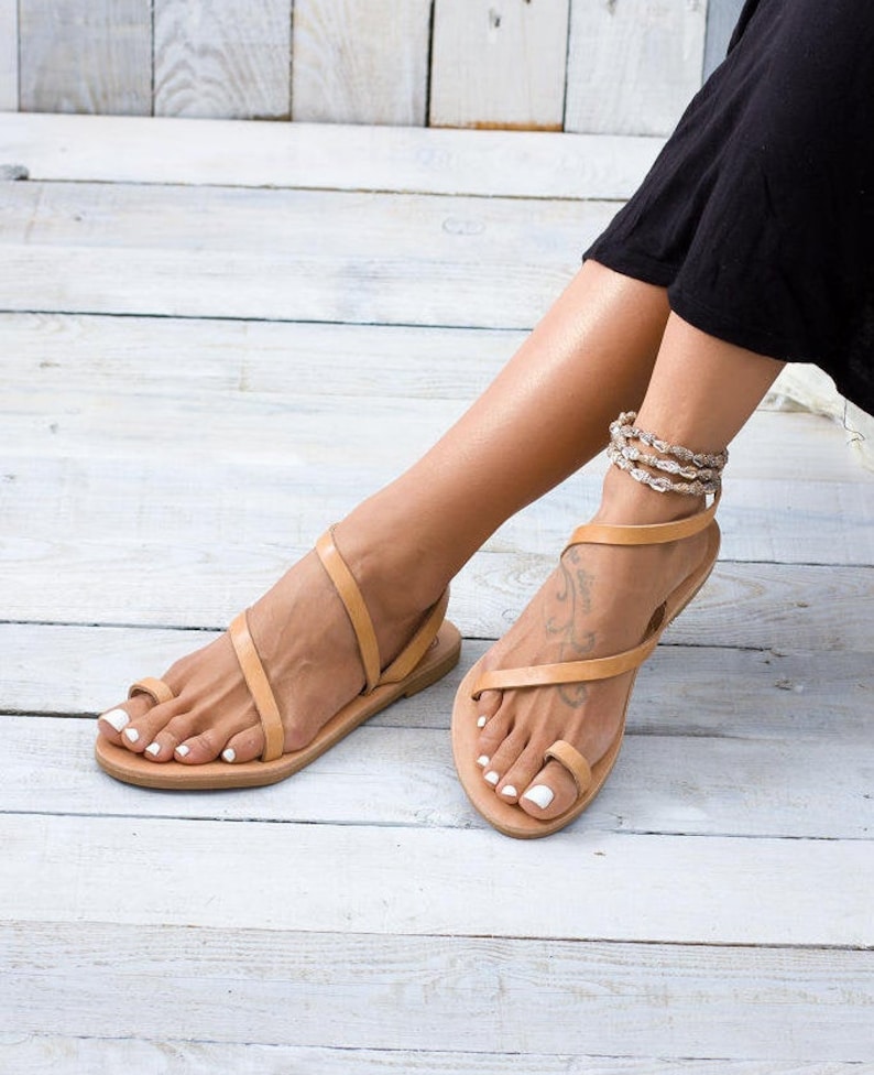 Close-up of the natural leather straps. Highlights the smooth texture of the vegetable-tanned leather.