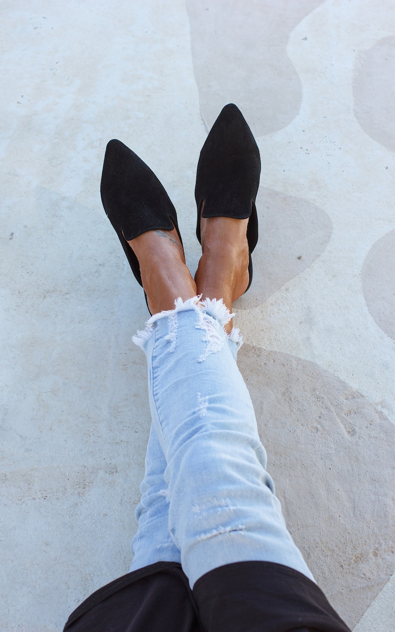 Woman wearing Loraine black suede mules — workwear look