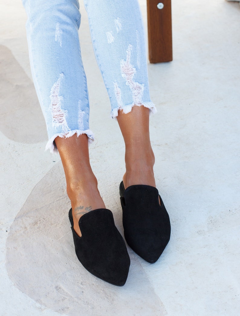 Close-up of black suede texture and stitching — Loraine mules