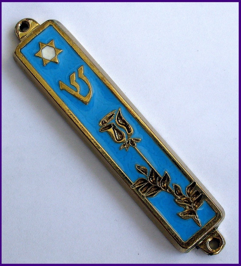 May include: A gold-colored mezuzah with a blue enamel background. The mezuzah features a Star of David, the Hebrew letter Shin, a rose, and a branch of leaves.