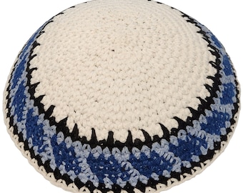 May include: A white crocheted kippah with a blue and black trim. The kippah has a round shape and is made of a soft, textured material.