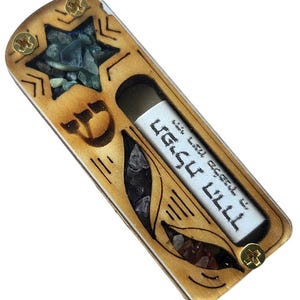 May include: A wooden mezuzah case with a Star of David design and a small scroll inside. The case is decorated with colourful stones and a Hebrew inscription.