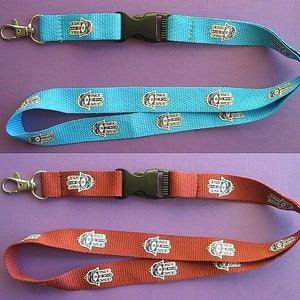 May include: Two lanyards with a hamsa hand design. One is blue and the other is red.