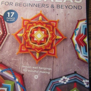 May include: A book cover titled "Yarn Mandalas for Beginners & Beyond" features colorful yarn mandalas. The cover includes the text "17 Patterns to craft!" and "Woven wall hangings for mindful making."